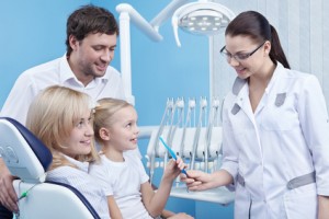 dentist giving family a toothbrush