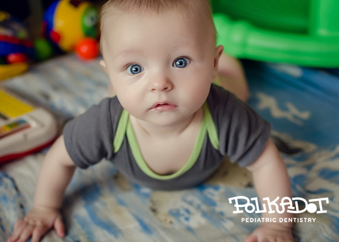 Infant lifting himself up